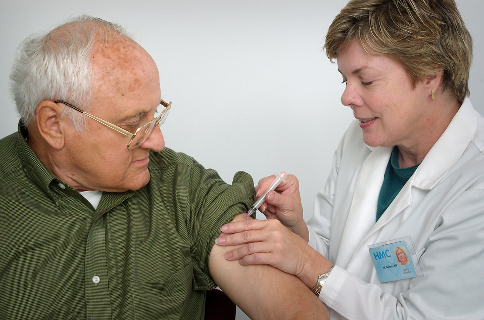 16729-a-nurse-giving-a-middle-aged-man-a-vaccination-shot-pv